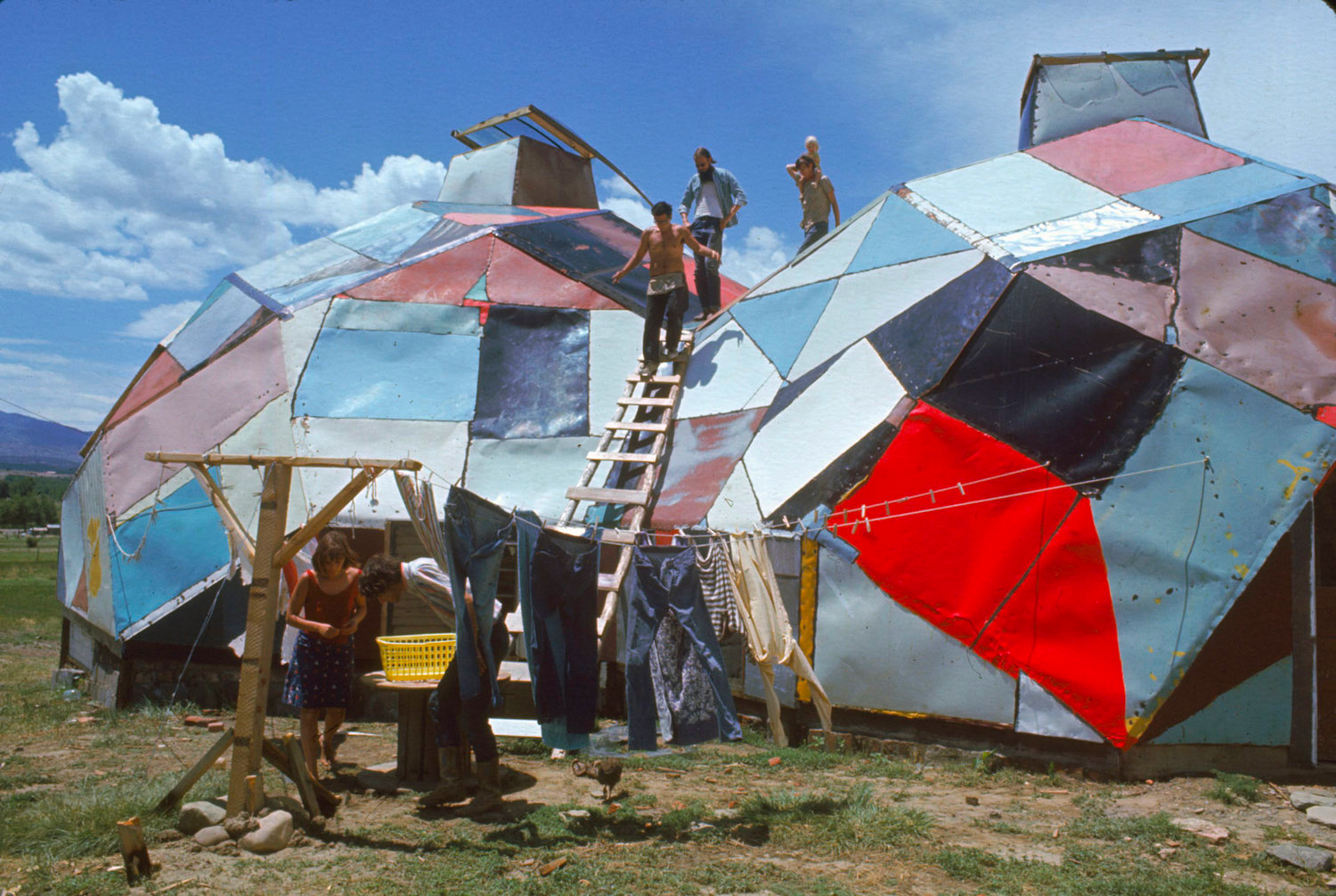Drop City communards emerge from their makeshift geodesic dome homes in the 60s.